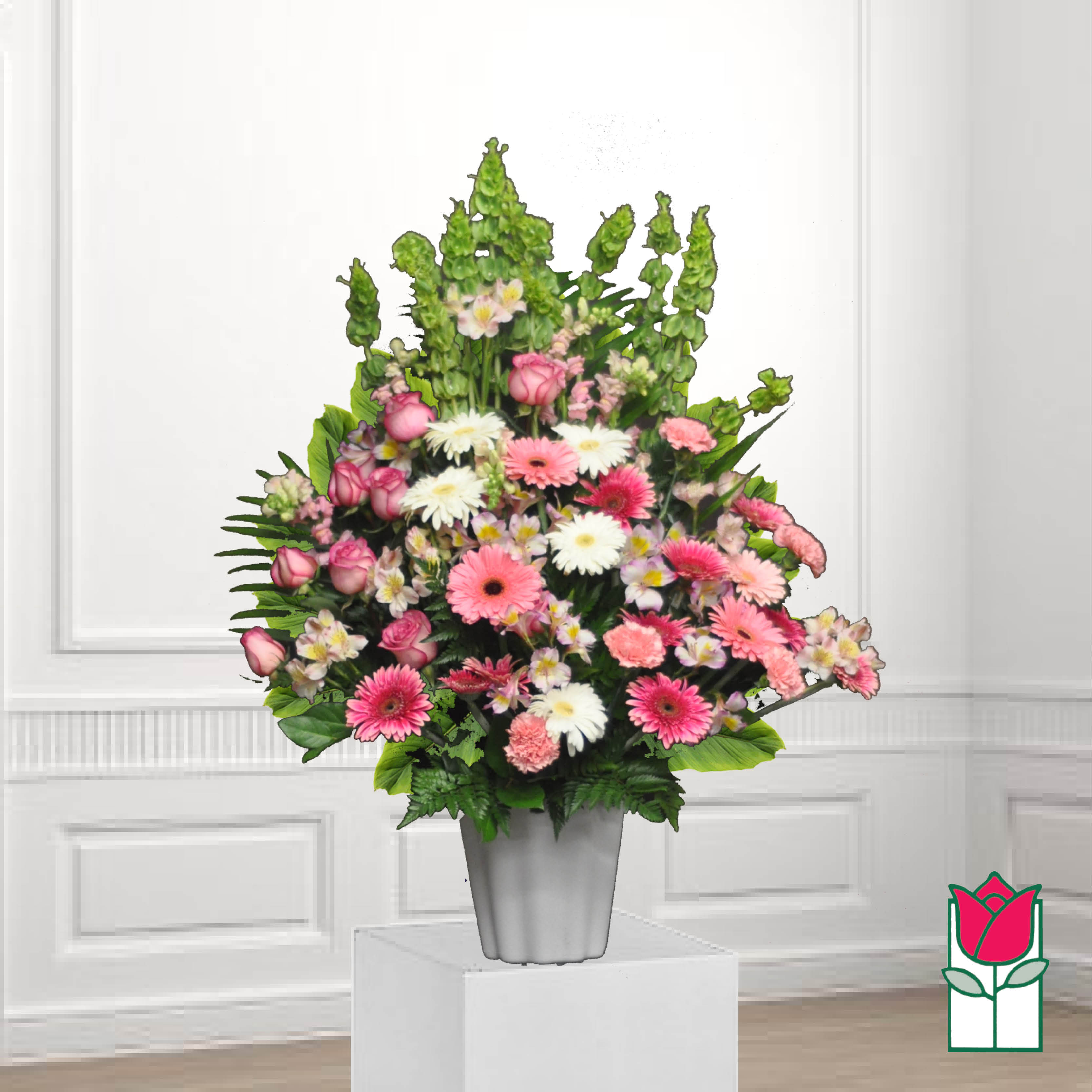 Pink and white mixed flowers arranged in a gray vase