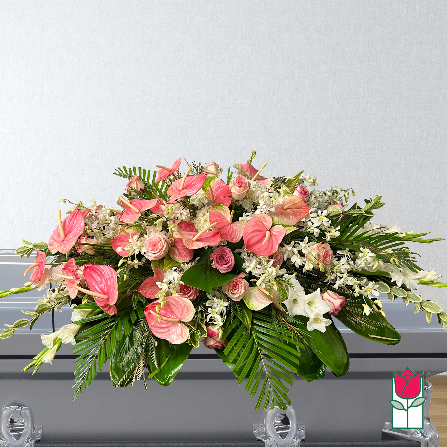 Large pink and white floral arrangement with tropical leaves