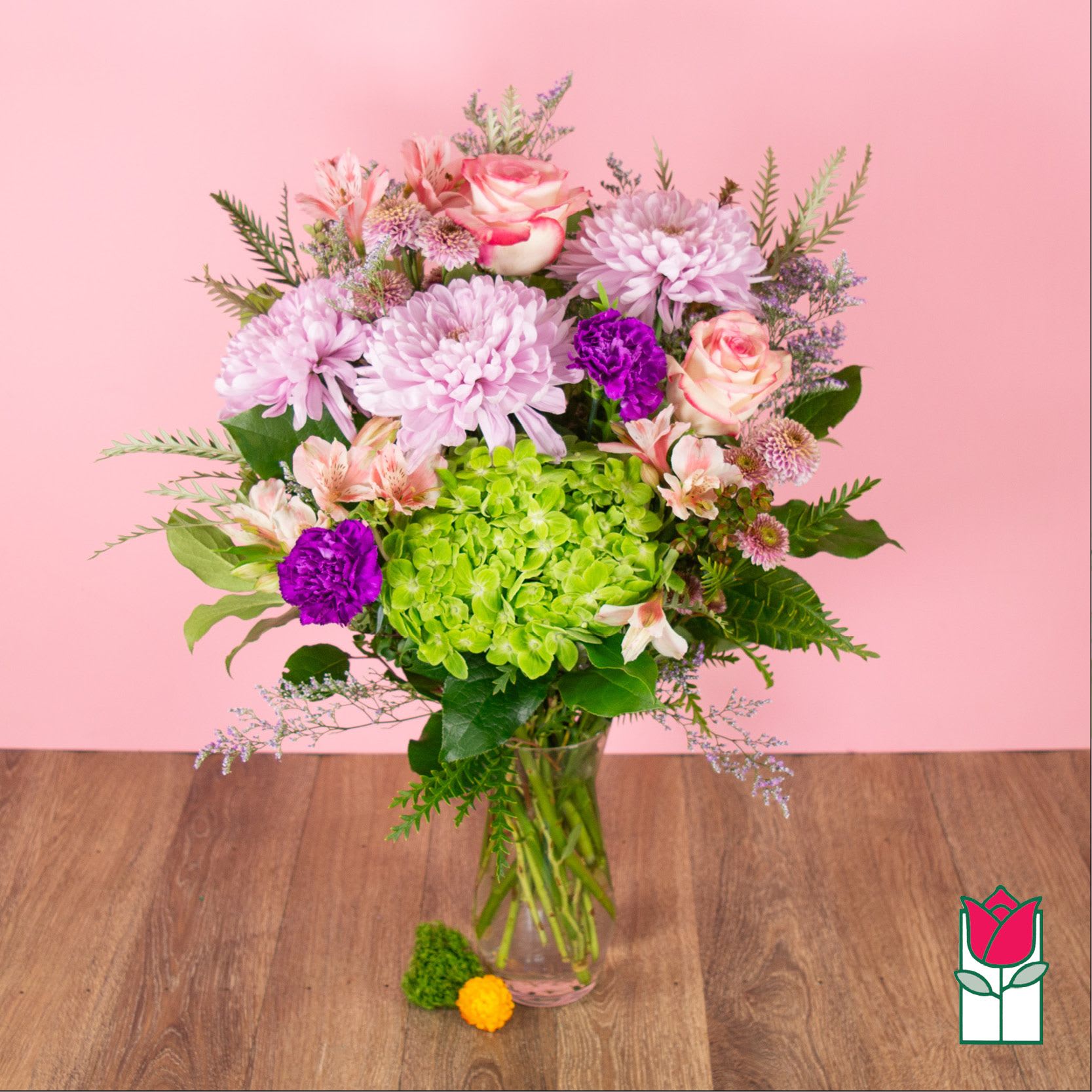 Bouquet of pink and purple flowers in a clear glass vase