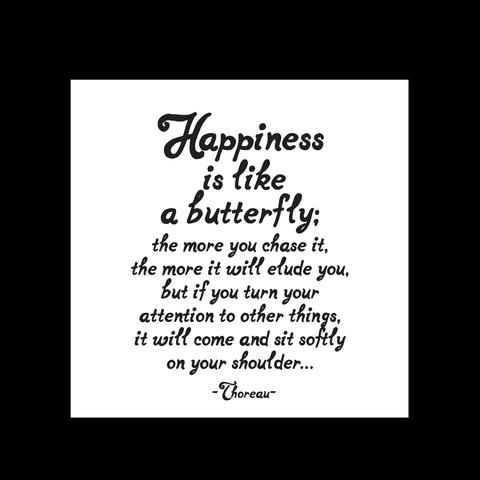 White sign with a black quote about happiness and a butterfly