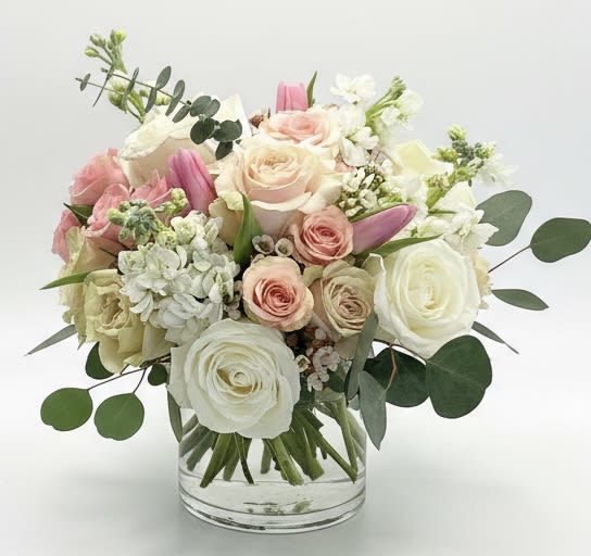 Pink and white rose bouquet in a clear glass vase
