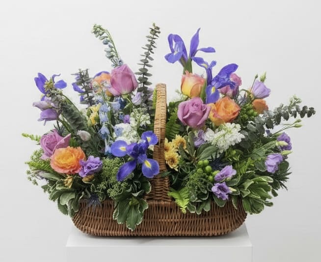 Basket arrangement of purple, pink, and orange flowers