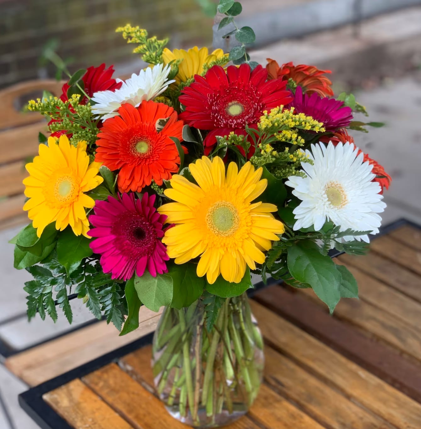 Colorful gerbera daisy bouquet in a clear glass vase