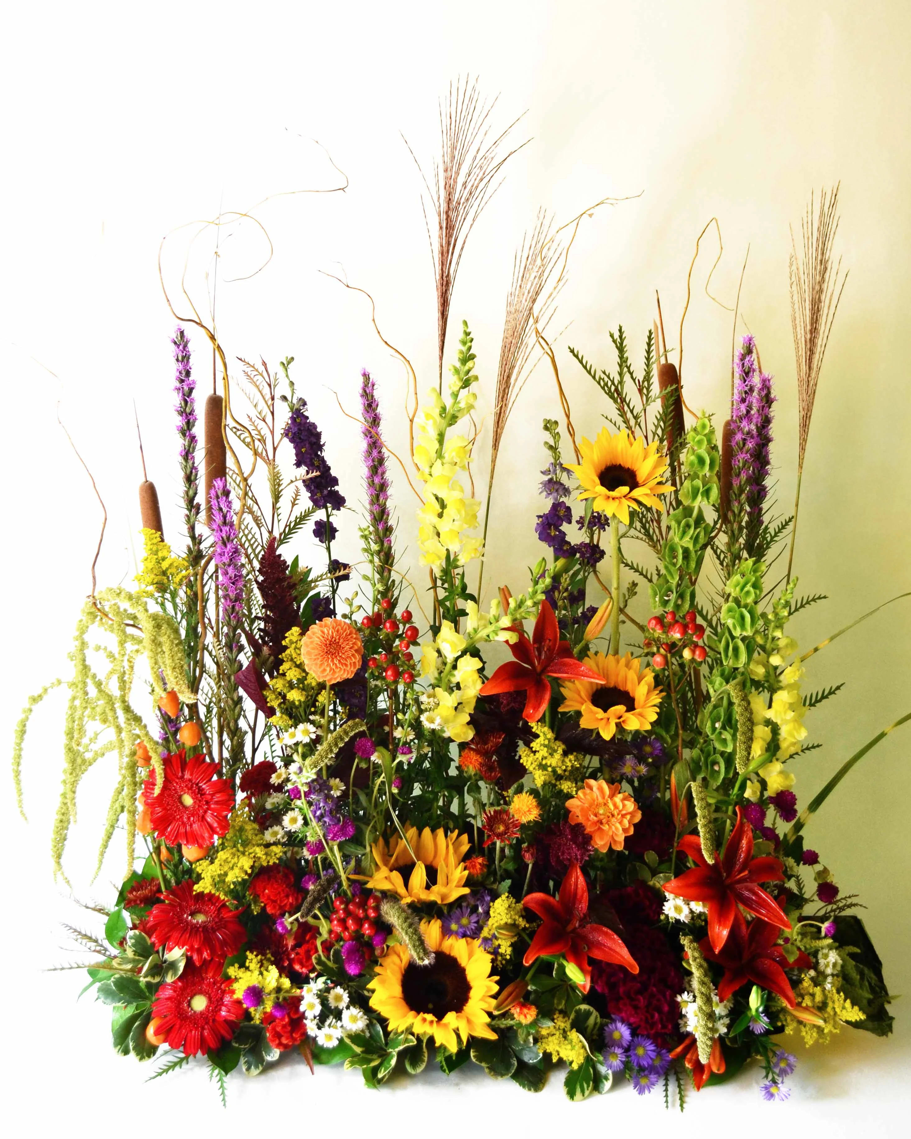 Warm Thoughts of Sympathy - Seasonal Flowers - A warm arrangement filled with thoughtfulness: Gerbera, Liatrus, Cattail, Solidago, Lilies, Sunflowers, Varigated Pittosporum, Bells of Ireland, Snapdragon, Hypericum, Hanging amaranthus, Seasonal grasses