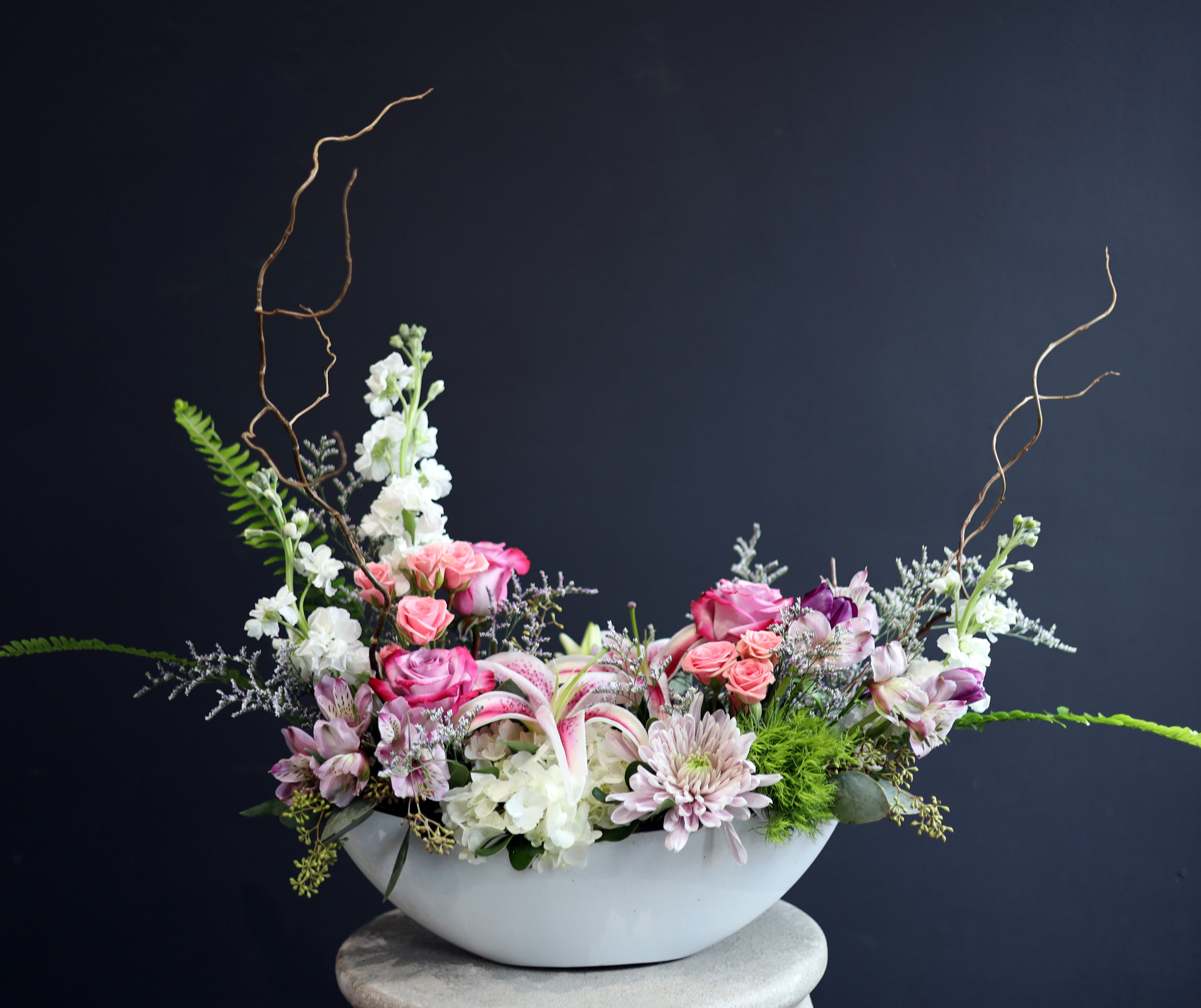 Love Boat - This boat vase is filled with lovely premium flowers! A few in this design are spray roses, pink stargazer, tulips, and white hydrangea! 