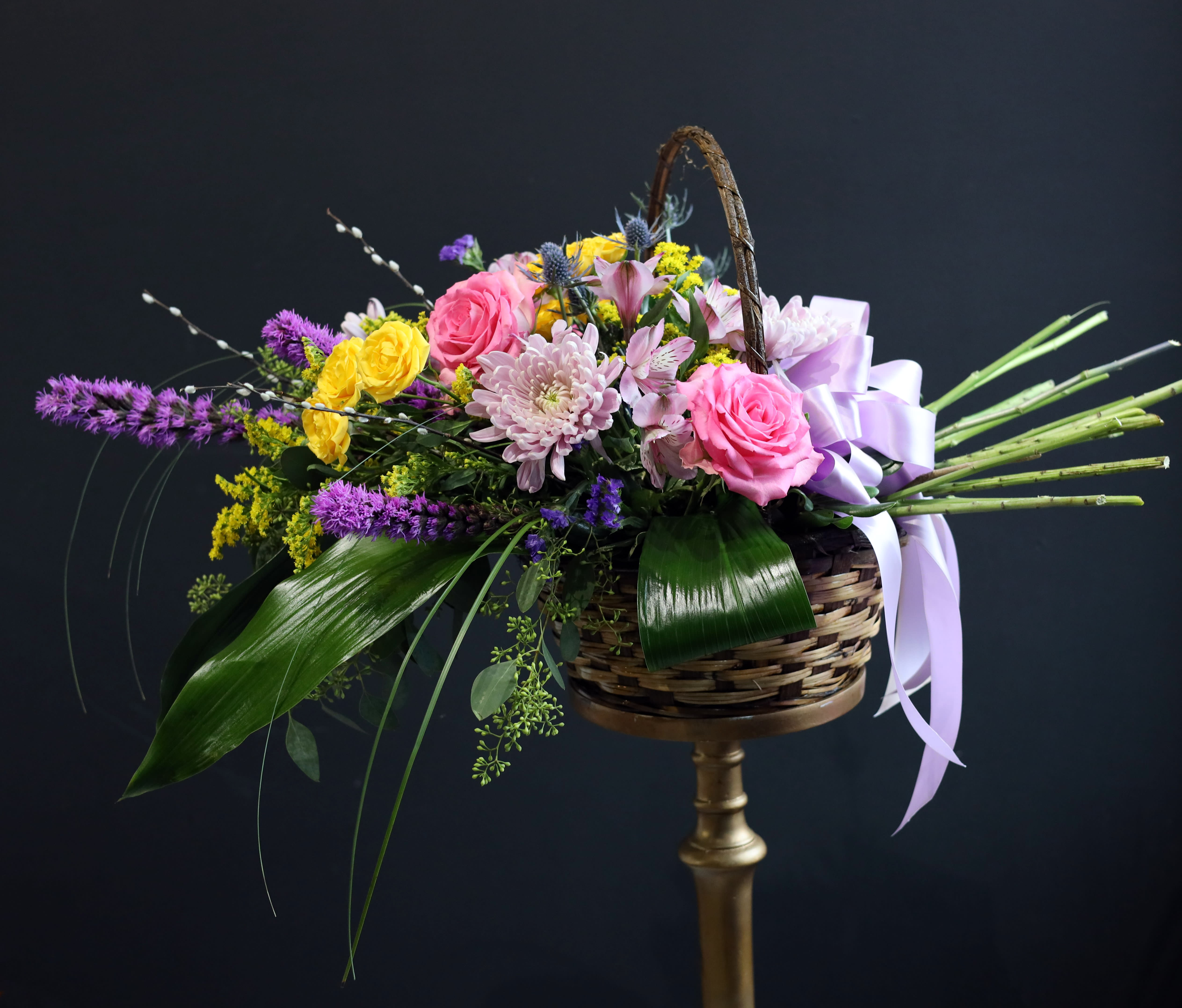 Forget Me Not - Gorgeous premium flowers filling a beautiful wicker basket designed to help a loved one through a difficult time and let them know they're in your thoughts. This lush arrangement has, but not limited to, pink roses, pink alstroemeria, yellow spray roses, and willow branches.