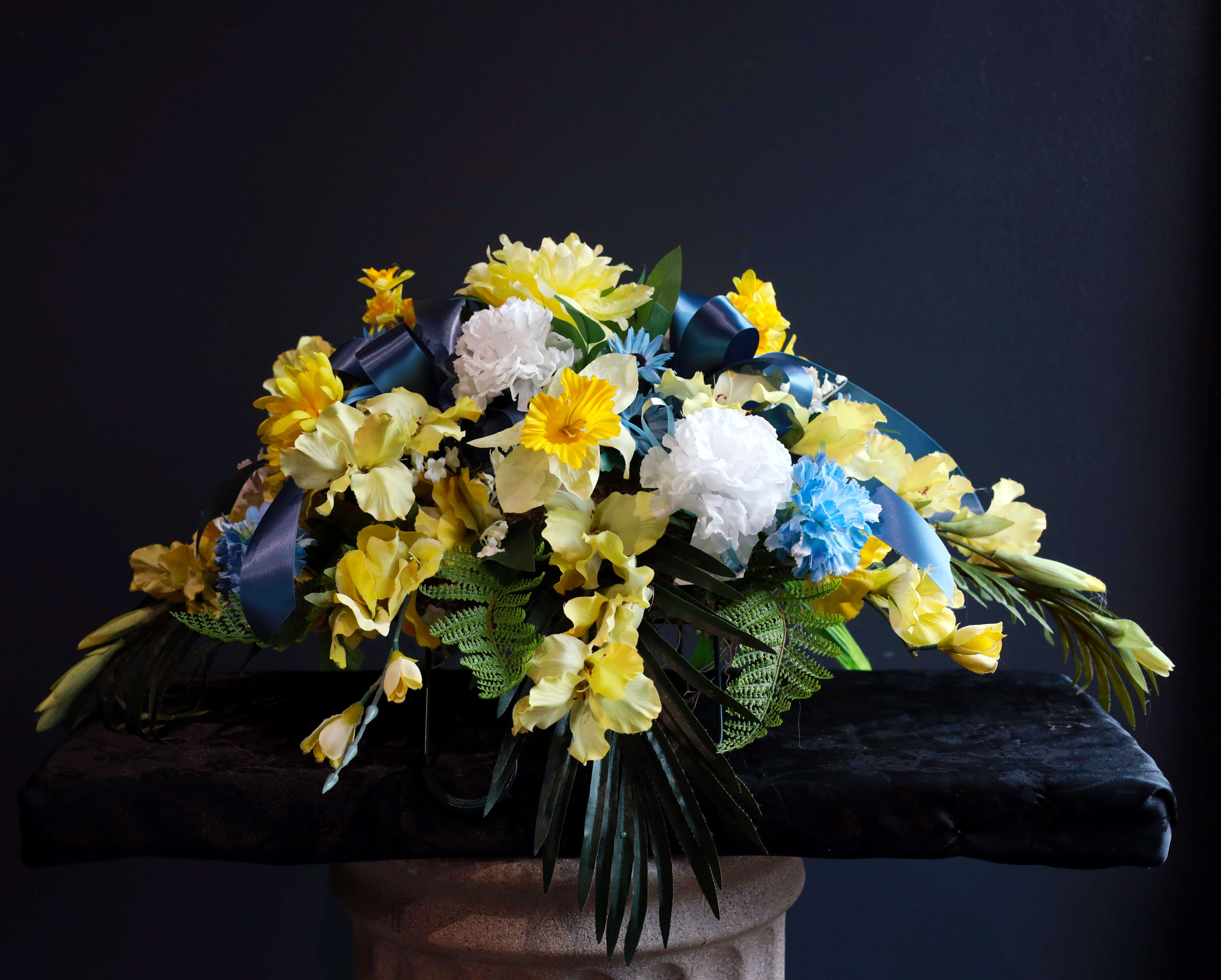 Artificial Spring Cemetery Saddle - A beautiful artificial spring flower cemetery saddle in honor of a lost loved one with honoring them with bright spring colors!
