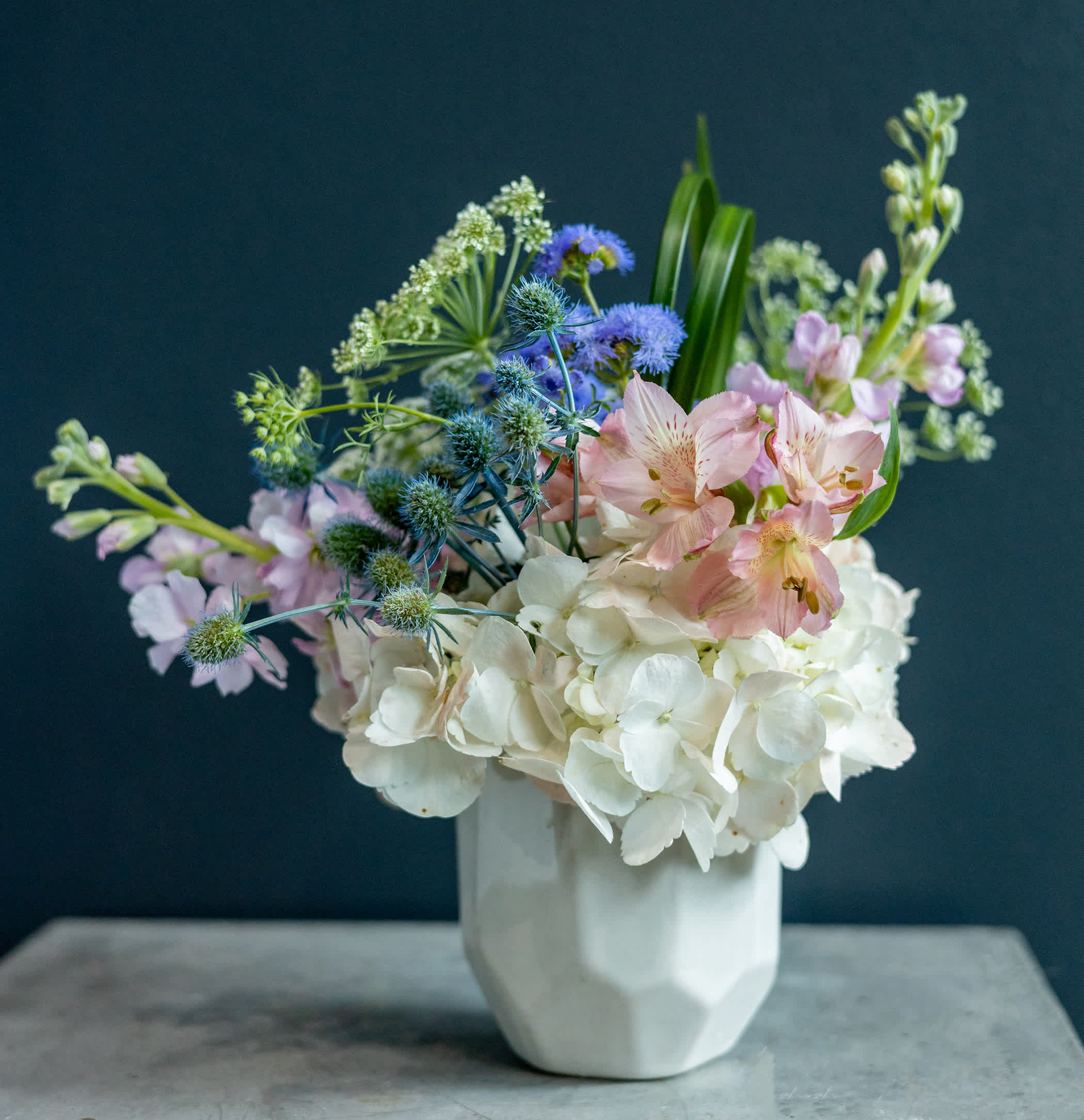 Pastel mixed bouquet in a white vase with white hydrangeas and pink alstroemeria