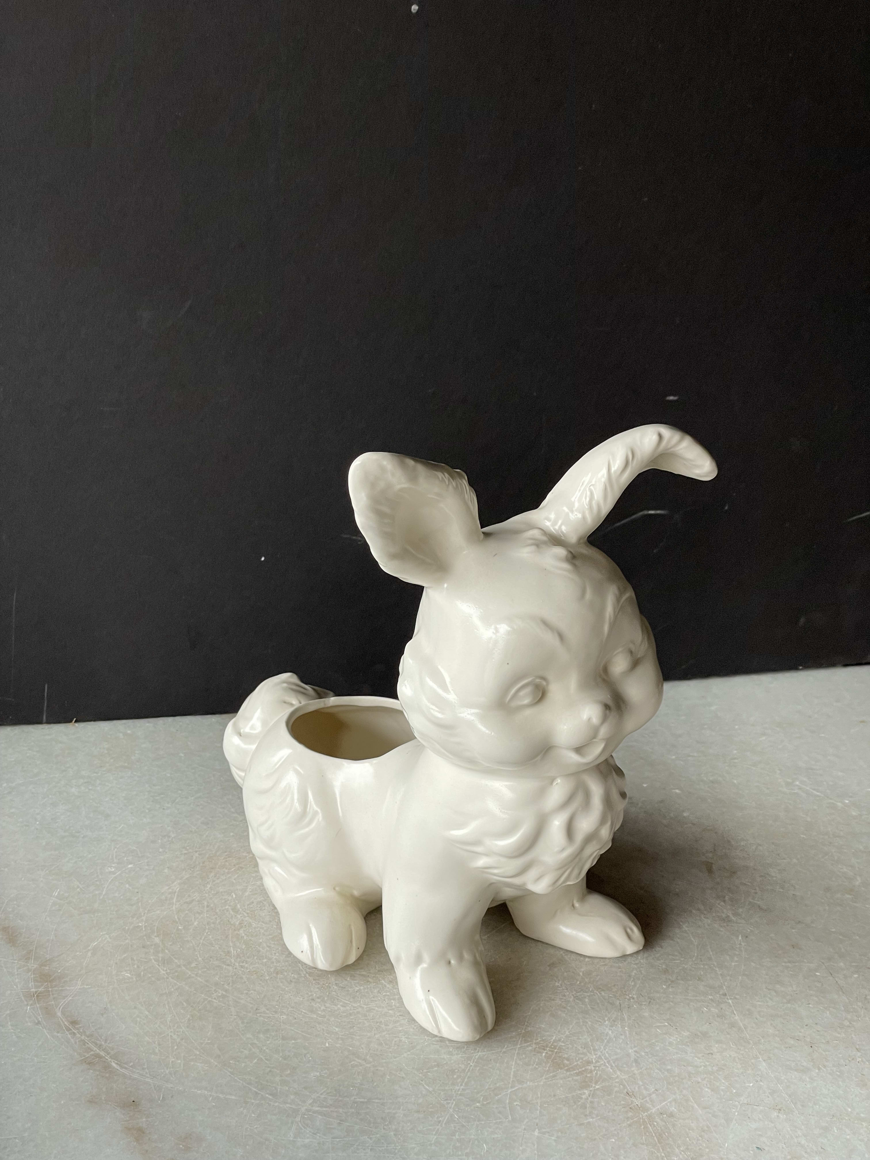 White ceramic bunny-shaped planter on a gray surface