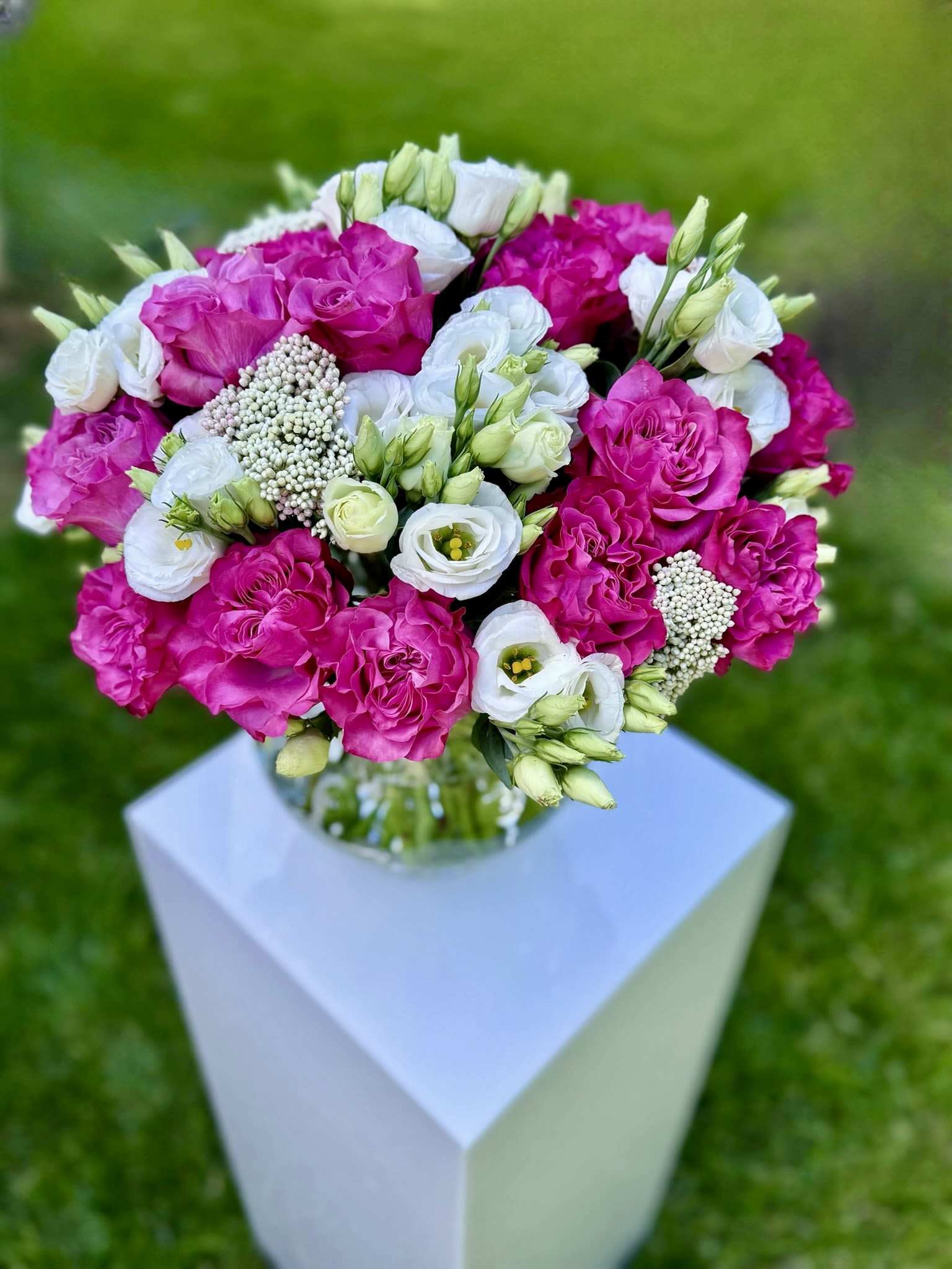 Bouquet of hot pink and white flowers in a glass vase