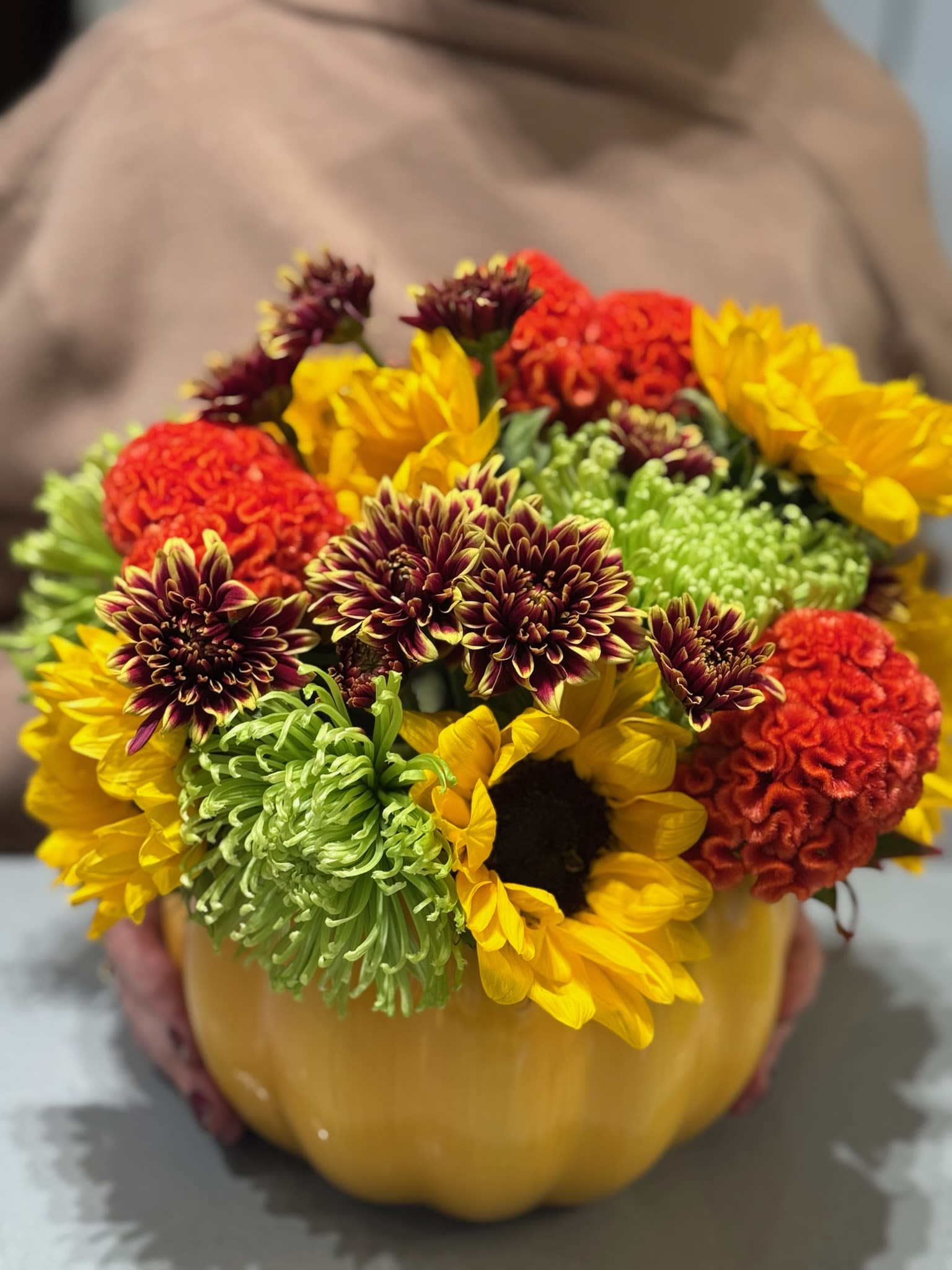 Mixed flowers arranged in a pumpkin-shaped container