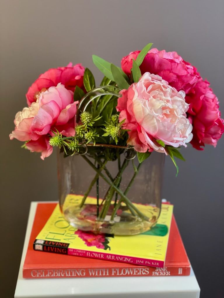 Pink peonies arranged in a clear glass vase
