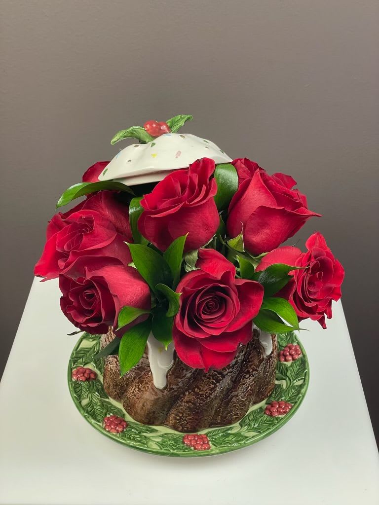 Bouquet of red roses arranged in a decorative cake-shaped container