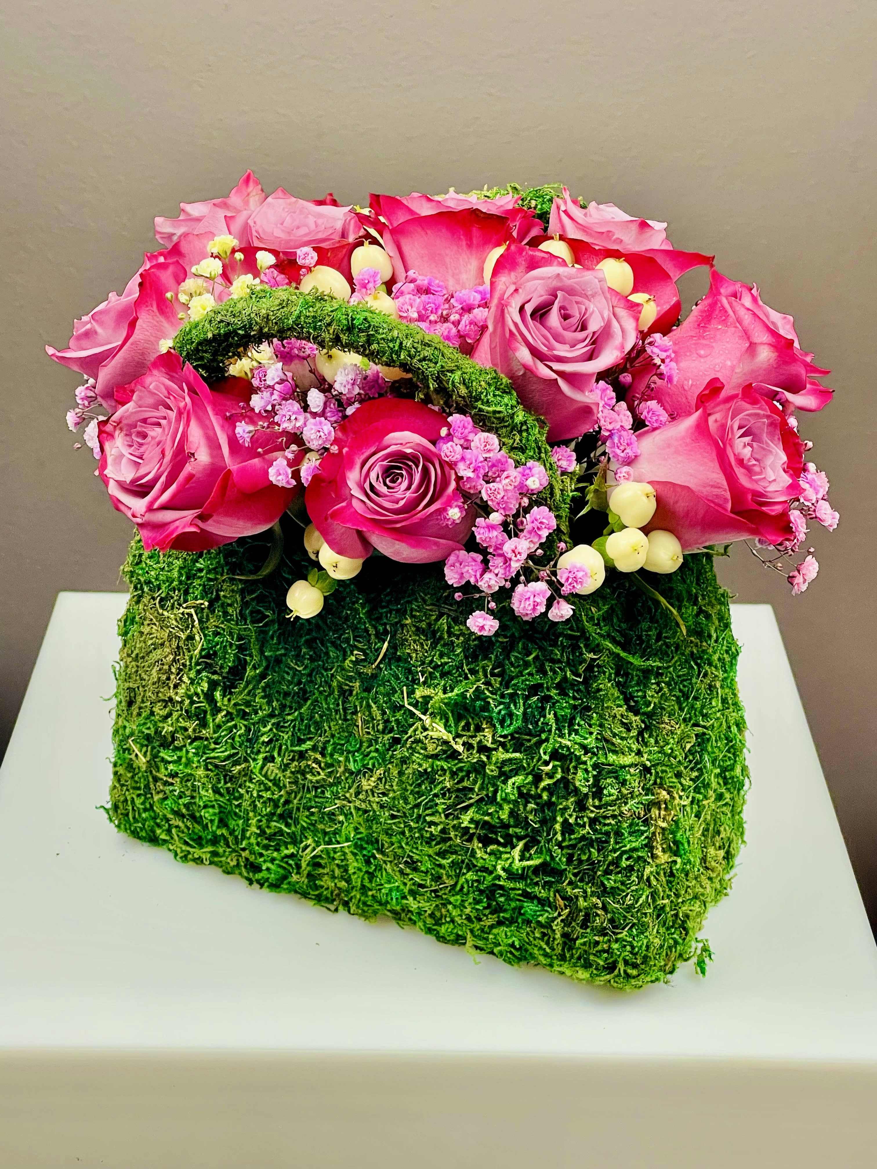 Lavender Blooms Clutch - The clutch design adds a touch of modernity and style, making it a perfect centerpiece for any occasion. Whether it's an Easter celebration, a spring event, or a special gathering, "Lavender Blooms Clutch" stands out as a symbol of refined floral artistry, bringing a sense of calm and charm to the surroundings.  Height 7 in Width 10 in
