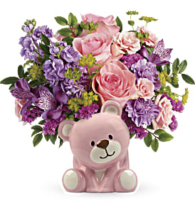 Pink and purple flower arrangement with a pink teddy bear container
