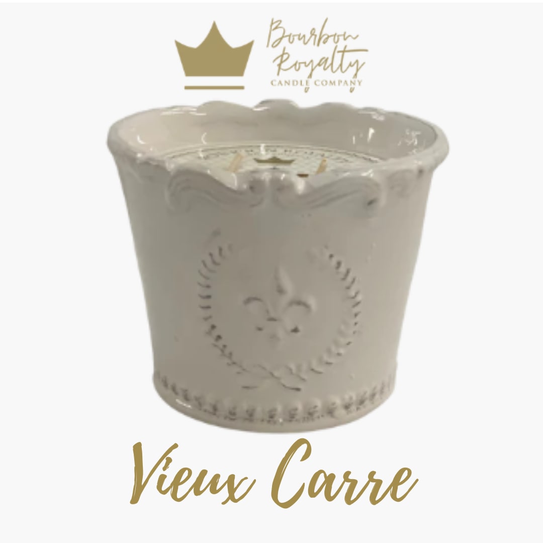 White decorative candle in a scalloped ceramic container