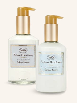 Two pump bottles of scented hand soap and hand cream