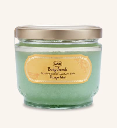 Jar of green body scrub with a gold lid