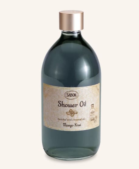 Bottle of shower oil with a gold cap and label