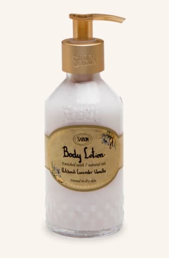 Bottle of Sabon body lotion with a gold pump dispenser