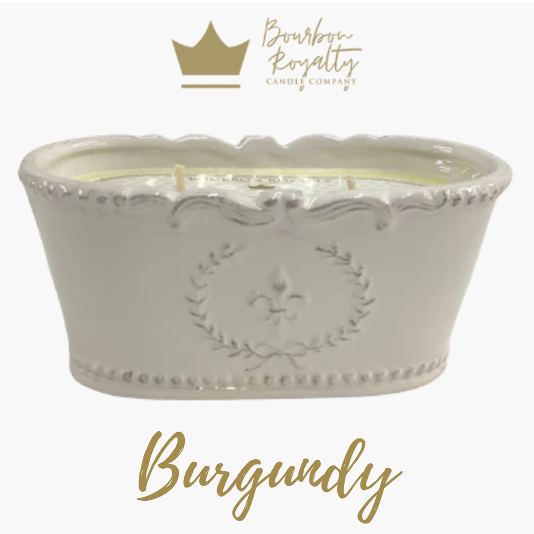 White ceramic candle vessel with gold logo and text