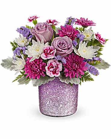 Bouquet of pink and lavender flowers in a glittery vase