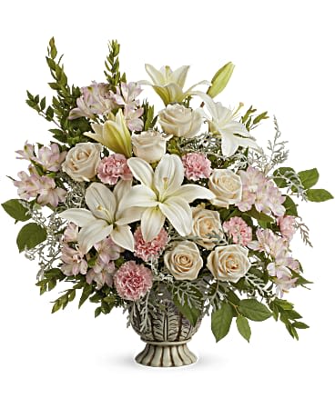 Bouquet of white lilies, cream roses, and pink carnations in a pedestal vase