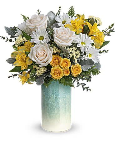 Bouquet of white and yellow flowers in a tall blue-green vase