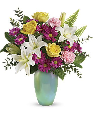 Bouquet of white lilies, yellow roses, and purple daisies in a green vase