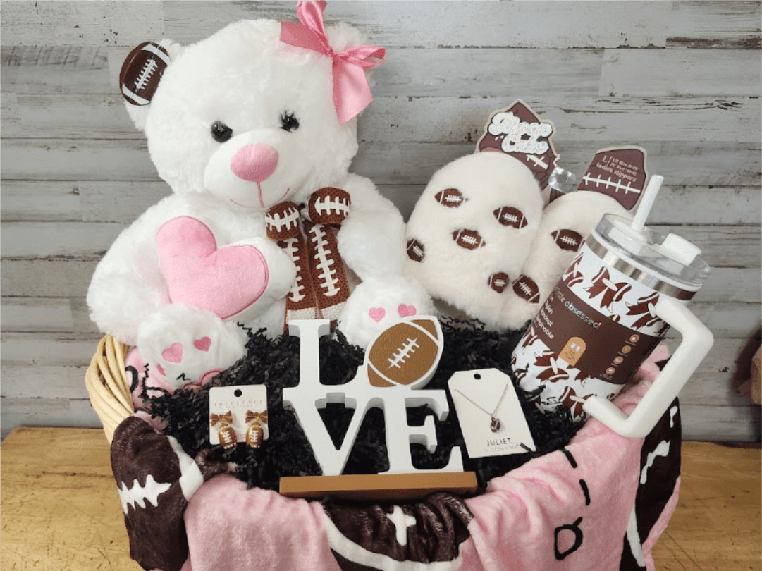 Basket of teddy bears and football-themed gifts with a LOVE sign