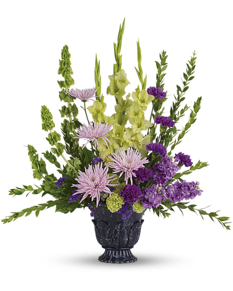 Purple and green floral arrangement in a black vase