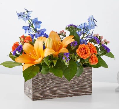 Orange lilies and roses in a rectangular wooden box