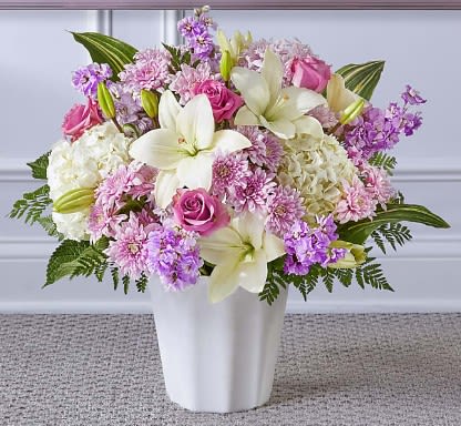 Pink and white floral arrangement in a white vase