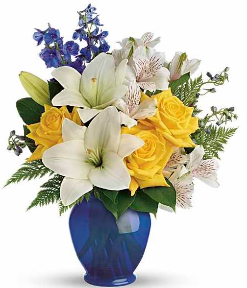 Bouquet of white lilies, yellow roses, and blue flowers in a blue vase