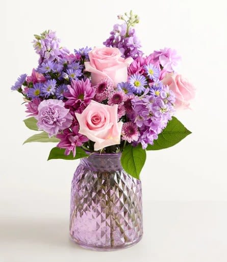 Daydream Bouquet - Soft pink roses with lavender and purple daisies, carnations, asters and mums in a faceted pink-lavender glass vase-lush, romantic pastel blooms for birthdays, Mother's Day, or thinking-of-you.