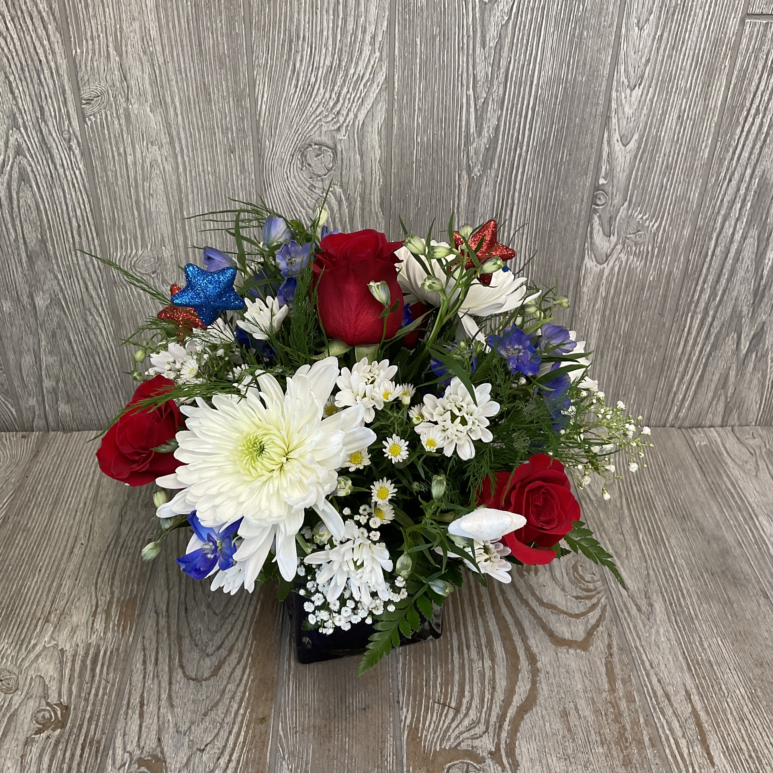America the Beautiful - Celebrate the Fourth of July this year with a beautiful arrangement of fresh cut flowers. Flowers may vary. 