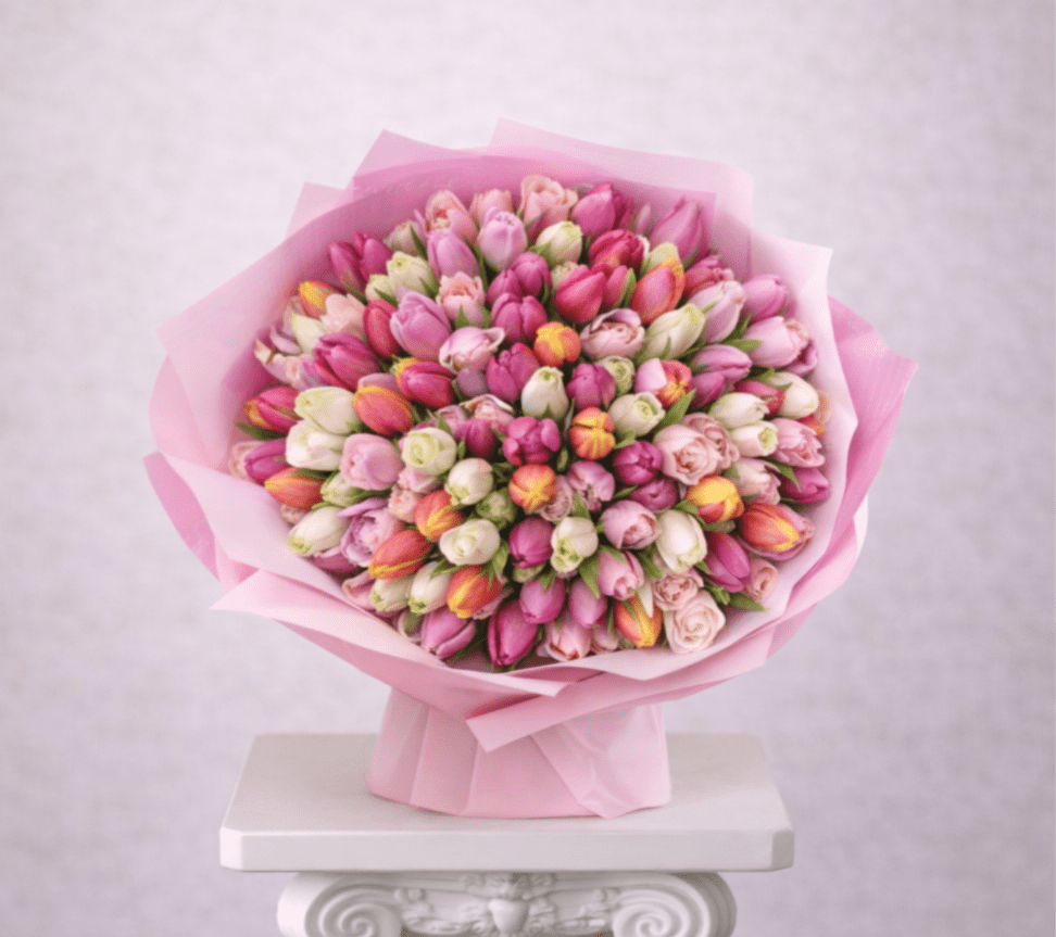 Bouquet of pink and white tulips wrapped in pink paper