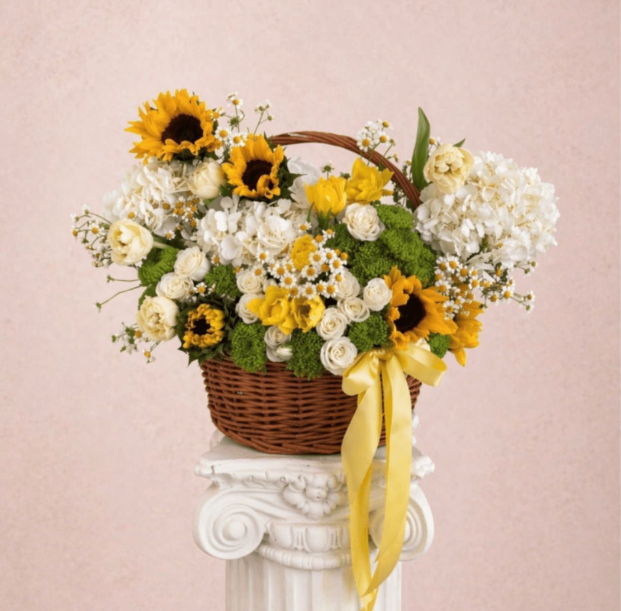 Sunshine  - Brighten any space with our Elegant Flower basket Arrangement! Bursting with vibrant blooms, this stunning display combines seasonal favorites with lush fillers.  Housed in a chic, reusable container, it makes a perfect centerpiece for any occasion be it a gift or a treat for yourself. Elevate your decor with this captivating arrangement that brings joy and sophistication to your home or office. Order yours today and let the beauty of flowers inspire you!