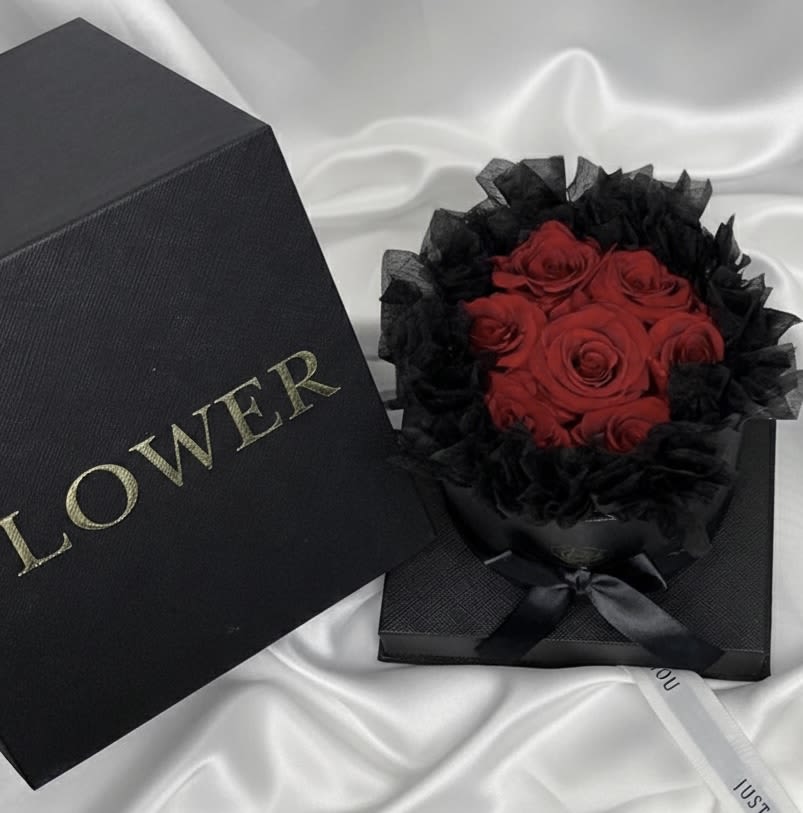 Eternal Red Prestige – Black Luxury Box - Bold, romantic, and undeniably sophisticated.  Our Eternal Red Prestige showcases premium preserved red roses arranged in a sleek black round luxury box with satin ribbon detailing. The dramatic black presentation enhances the richness of the red roses, creating a striking and modern romantic statement.  Preserved roses retain their beauty for months — even years — offering a lasting reminder of love and passion.  Perfect for anniversaries, romantic surprises, Valentine’s Day, or meaningful celebrations.  A powerful yet elegant gift designed to stand out.