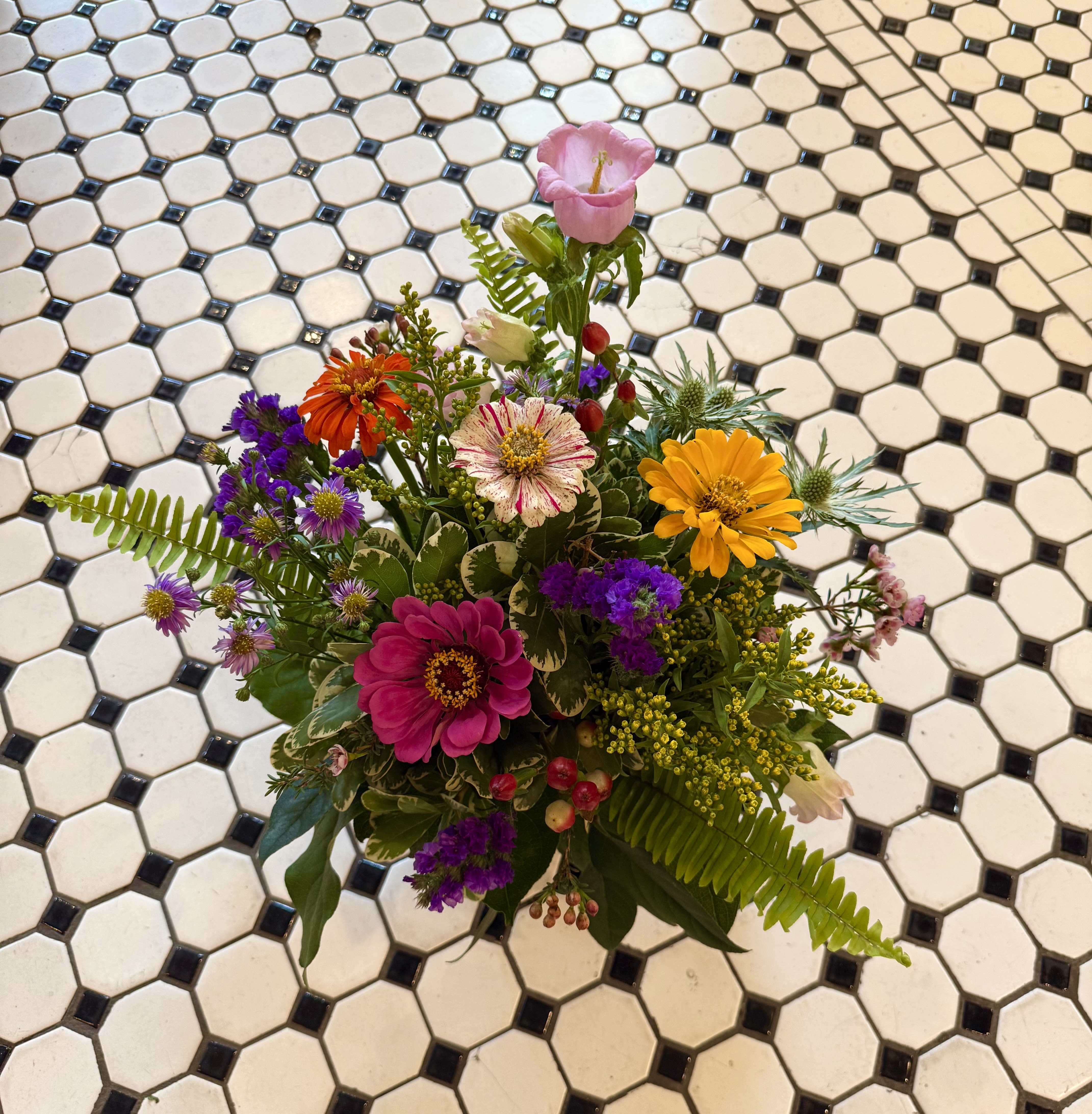 Wildflower Wonder  - The Wildflower Wonder is a stunning design in vibrant colors. Featuring a selection of seasonal locally-grown, fresh cut flowers from our own "Secret Garden". This beautiful arrangement is the perfect gift to brighten any space.  Approx. 10 inches wide by 11 inches tall for a standard size   