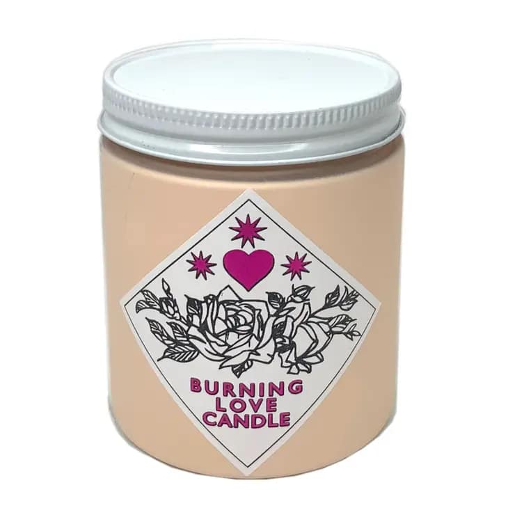 Beige candle in a glass jar with a pink heart label