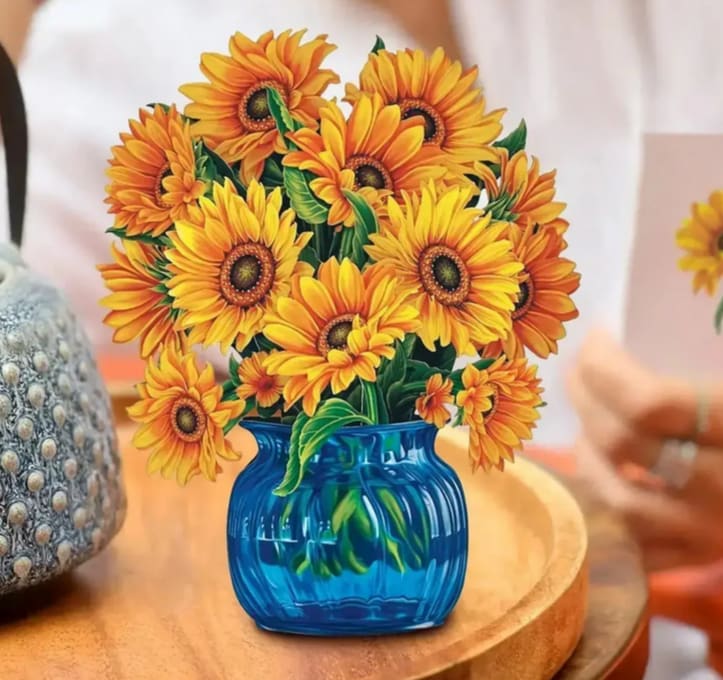Sunflower bouquet in a blue vase on a table