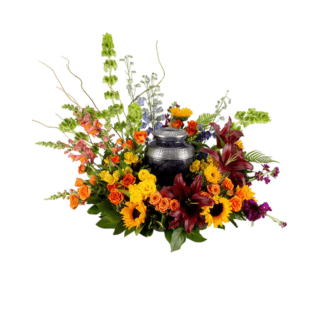 Dawn of Spring Urn Surround - This colorful arrangement cradles the urn in a vibrant embrace. Colors and flowers may change based off of season and availability.