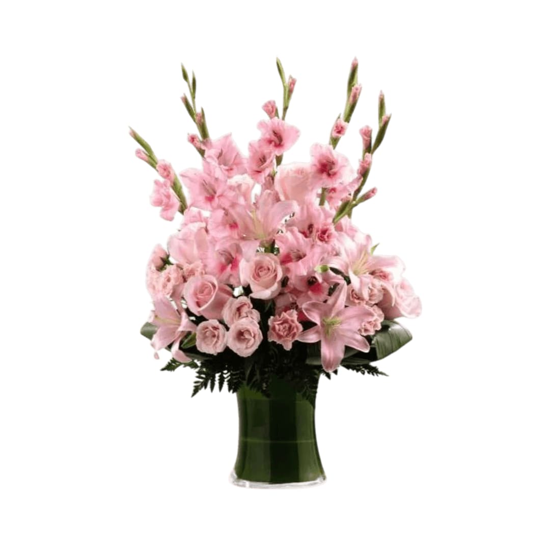 Lovely Tribute  - Lovely Tribute Bouquet is a warm and blushing display of peace and beauty, set to honor the deceased and bring comfort to family and friends. Pink gladiolus, pale pink roses, bi-color pink roses, pink Asiatic lilies and an assortment of lush greens create a sophisticated arrangement seated in a clear glass gathering vase, symbolizing your heartfelt love and sympathy.