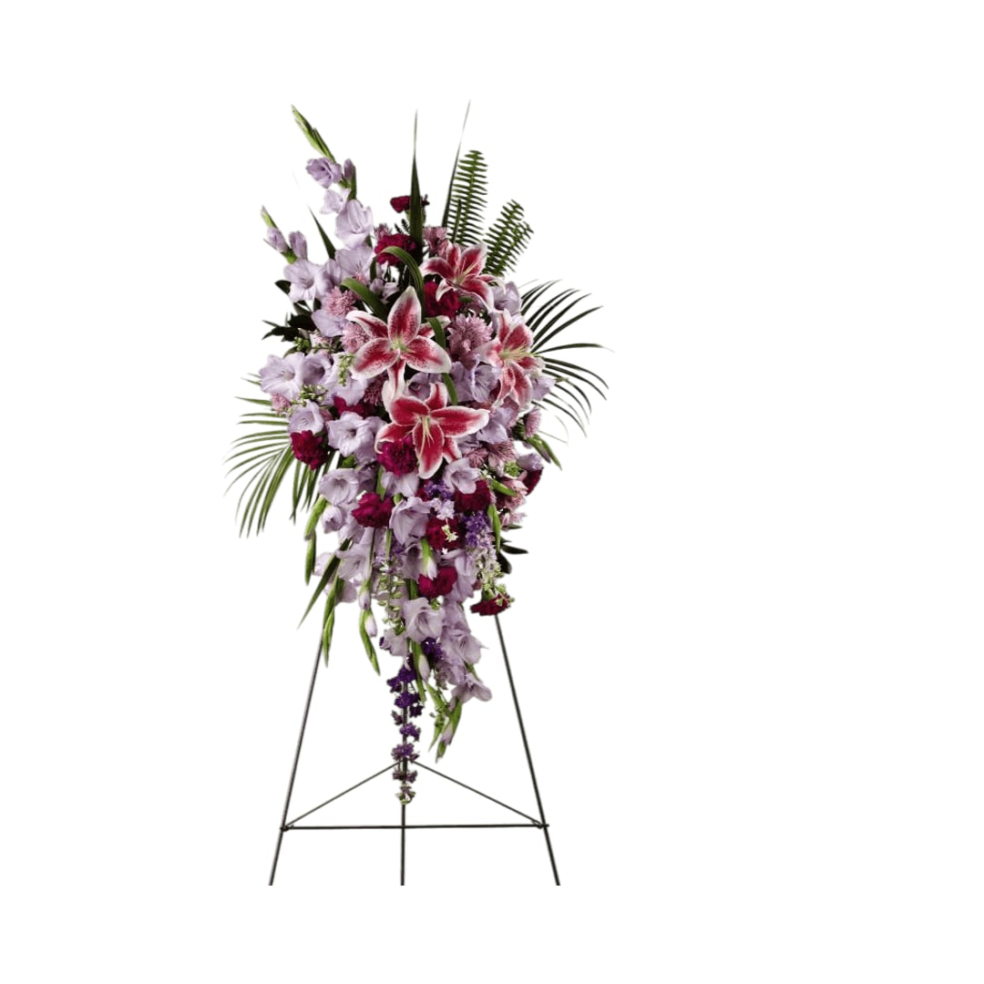 A touching tribute standing spray - Tender Touch Standing Spray creates an elegant display of  beauty and color to enhance their final tribute. Lavender gladiolus,  Stargazer lilies, fuchsia carnations, purple larkspur, lavender Peruvian  lilies, lavender chrysanthemums, sword fern fronds, emerald palm fronds  and other assorted greens are gorgeously arranged to create a  sophisticated standing spray. Displayed on a wire easel, this  arrangement will add to the sophistication of their service with each  fragrant bloom.    48h x 26w