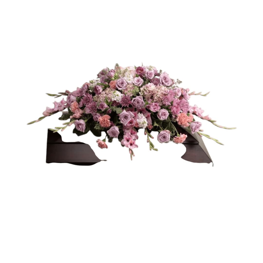 Immorata Casket Spray - Immorata Casket Spray offers soft beauty and blushing  comfort to honor the life of the deceased. Lavender roses,  chrysanthemums and parrot tulips are elegantly arranged amongst pink  carnations, gladiolus, stock, hydrangea and lush greens to create a  presentation, intended to bedeck the top of the casket, that evokes  sweet memories of your loved one for their final farewell service.  