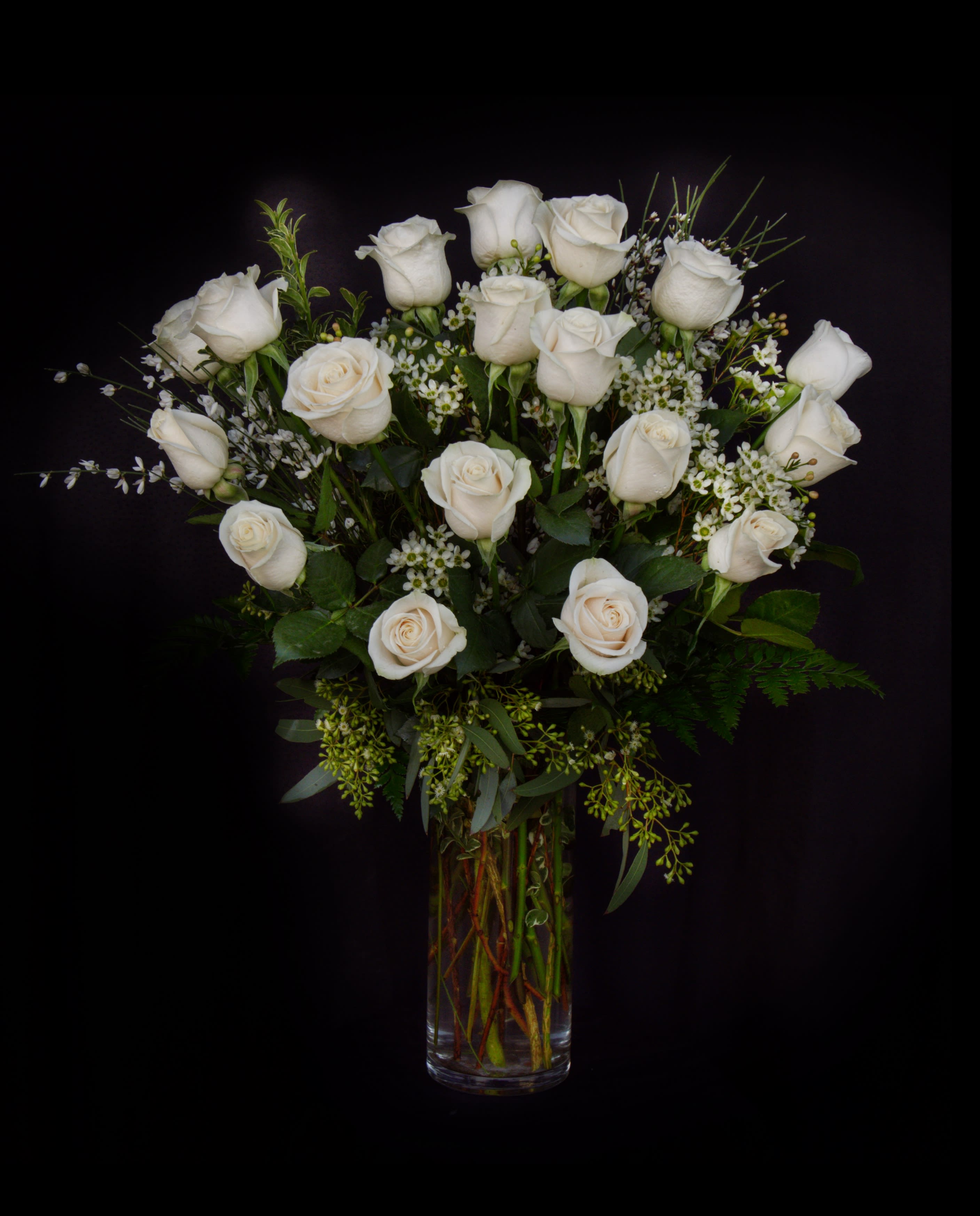 Jasmine Rose - Ecuadorian white roses and accents in a tall vase. STANDARD: 18 ROSES DELUXE: 24 ROSES PREMIUM: 36 ROSES
