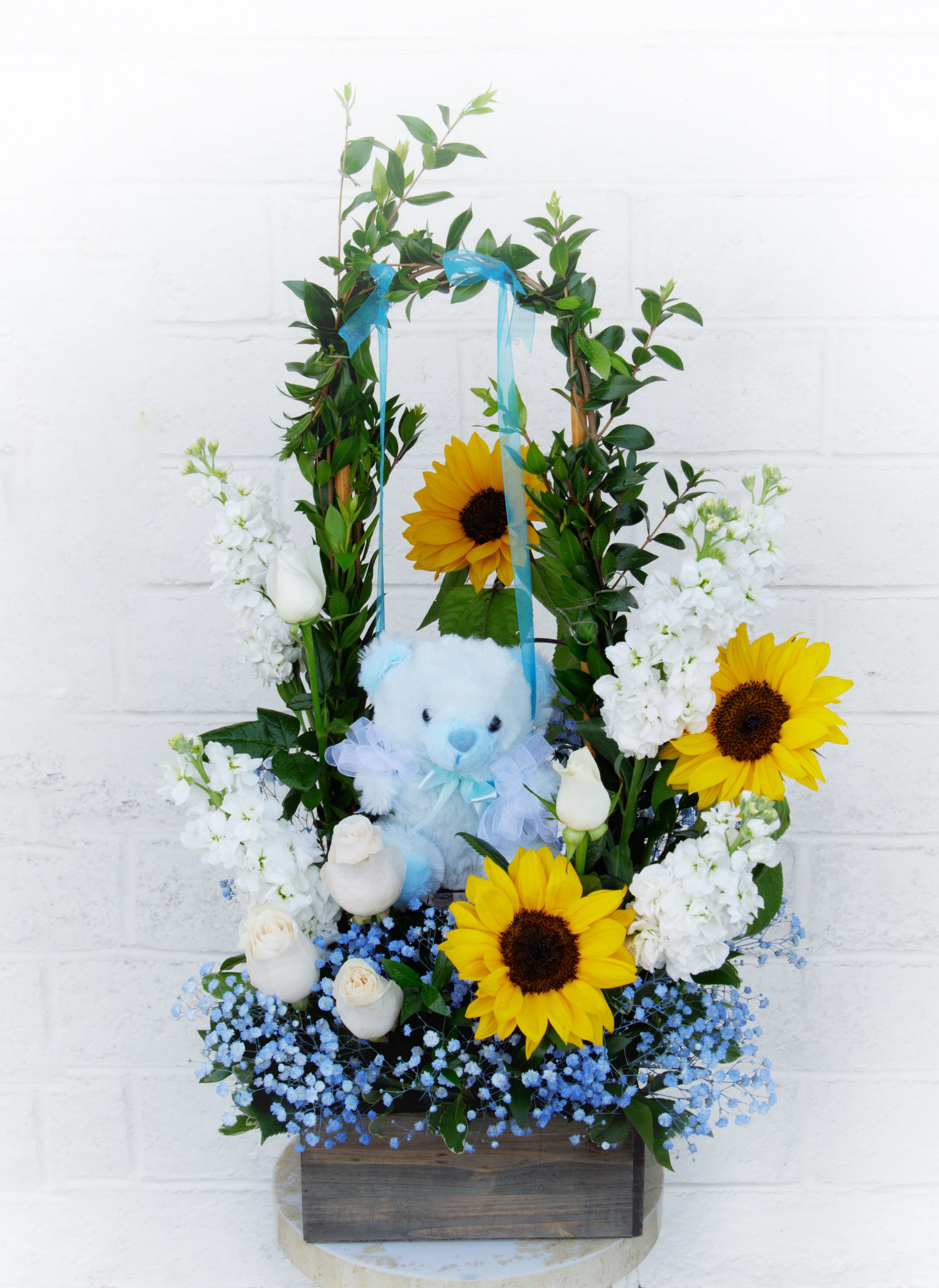 Sunflower and white rose arrangement with a blue teddy bear in a wooden box