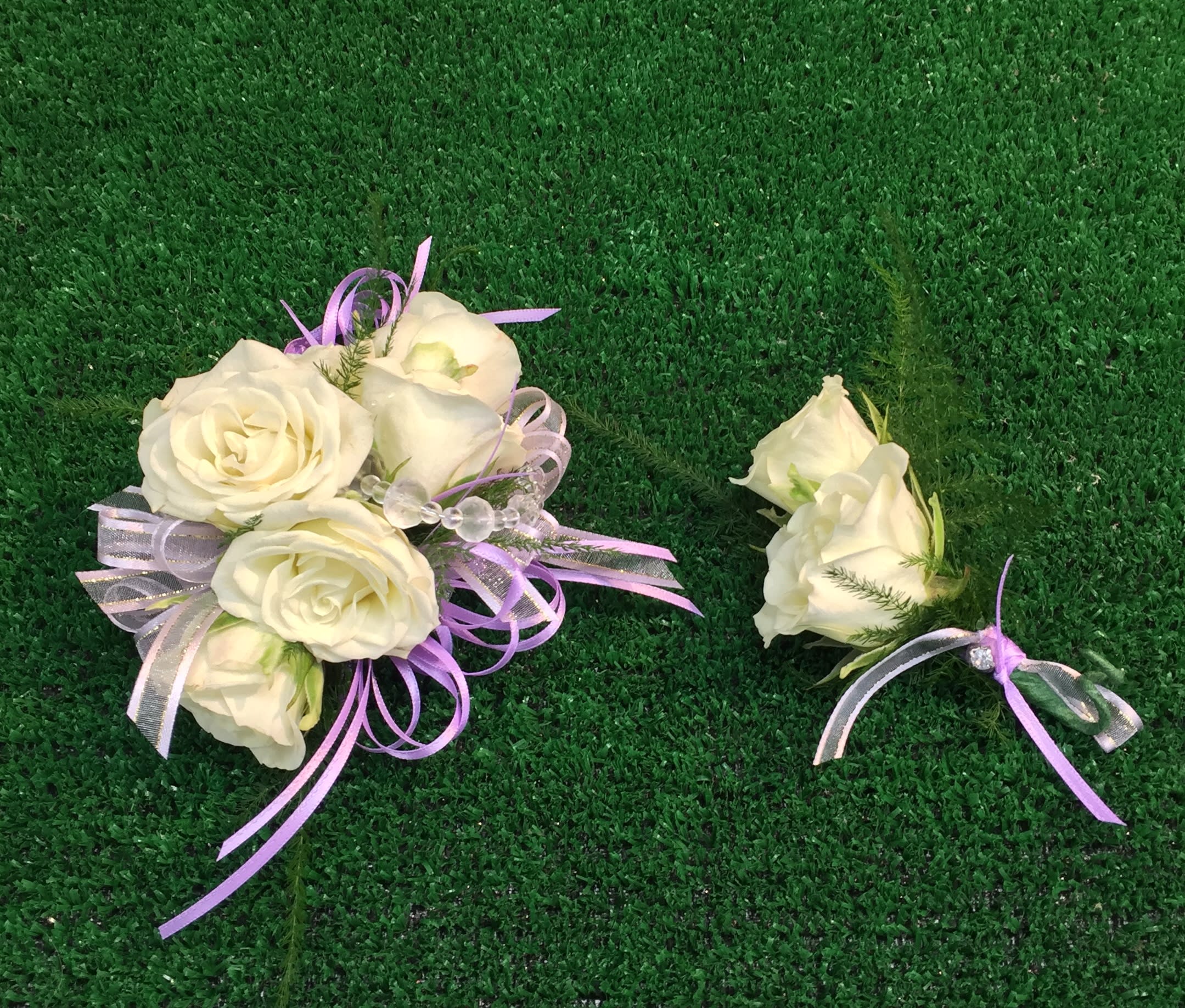 White rose bouquet and matching boutonniere with lavender ribbon