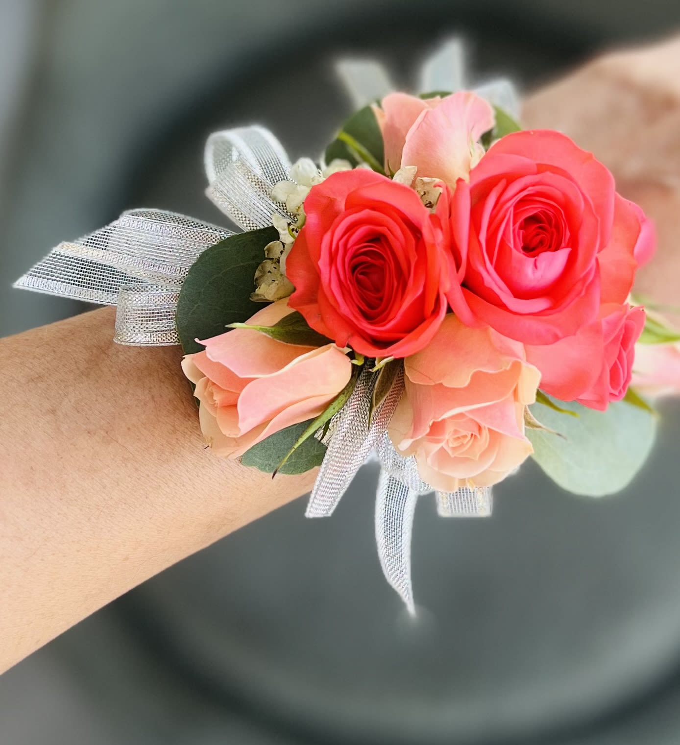 Pink and coral rose wrist corsage with silver ribbon